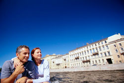 Seems to be happy couple taking a water way to explore St. Petersburg during summer